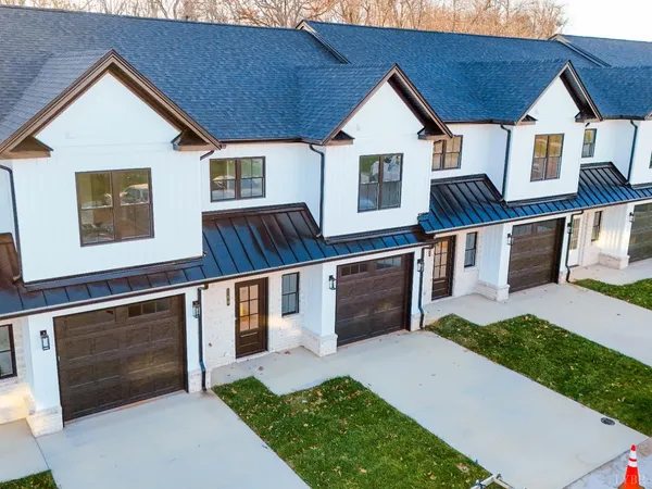 a view of a kitchen with kitchen island a sink wooden floor and a window