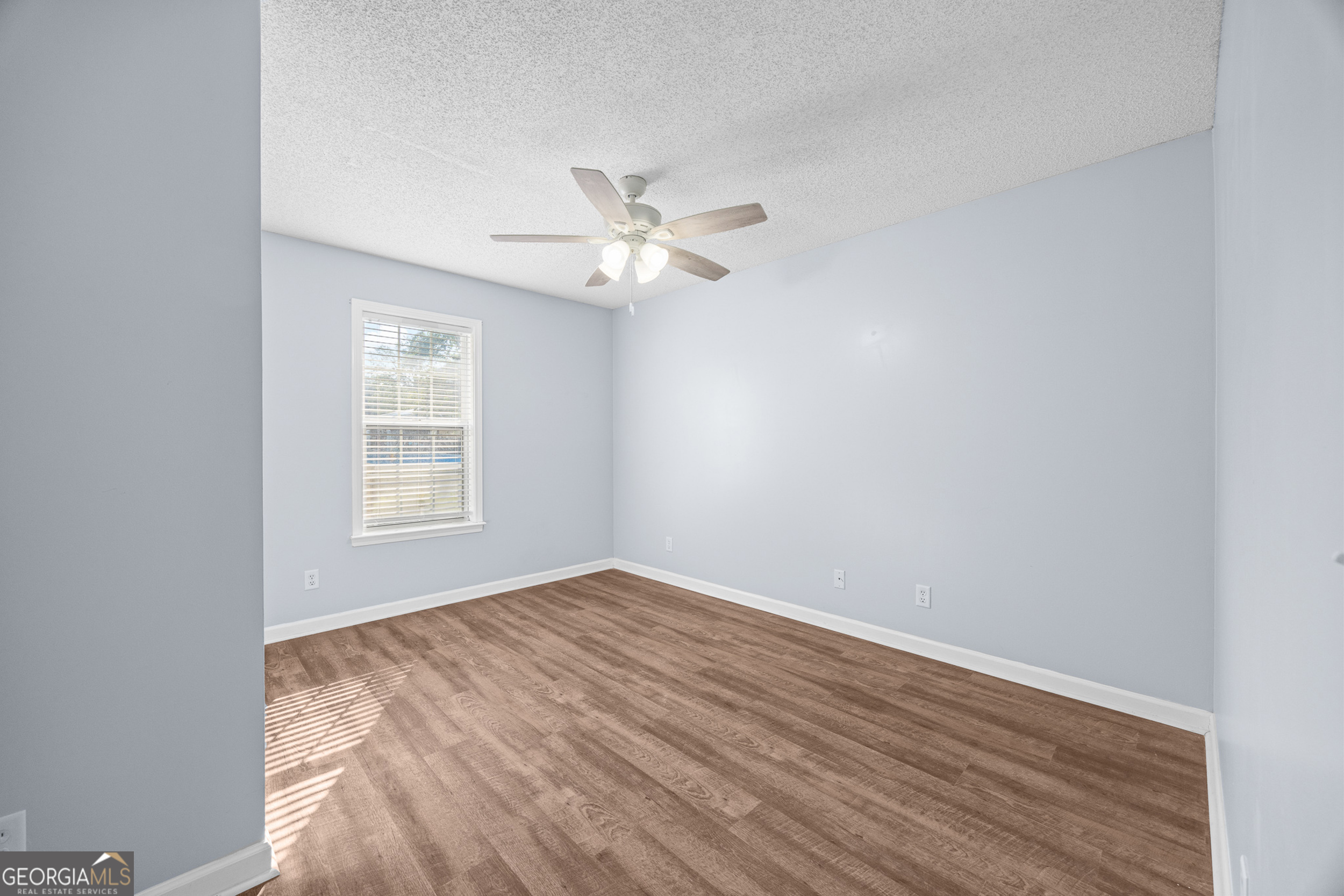108 Crossing Circle Rincon, GA 31326 - Photo 13 of 26 wooden floor in an empty room with a window