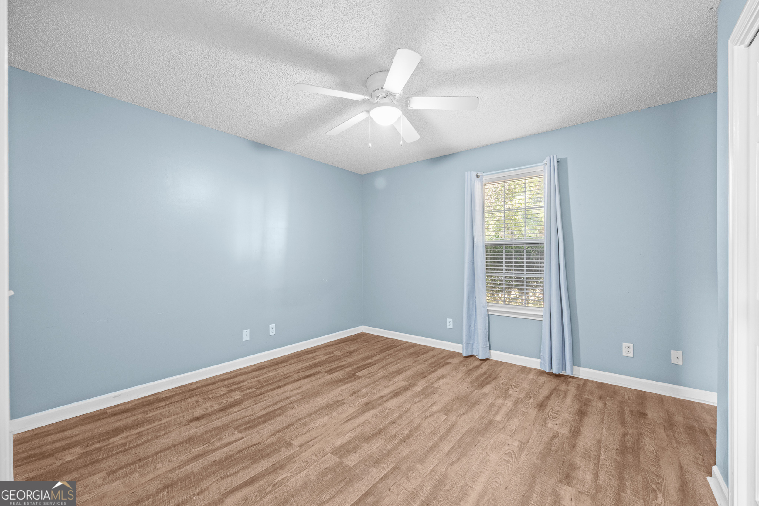 108 Crossing Circle Rincon, GA 31326 - Photo 15 of 26 an empty room with wooden floor fan and windows