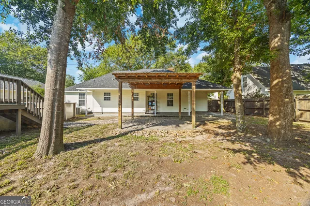 front view of a house with a large tree