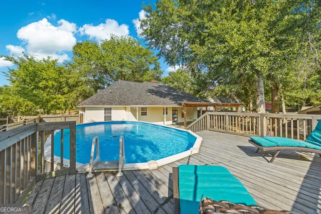 a view of a house with backyard and sitting area