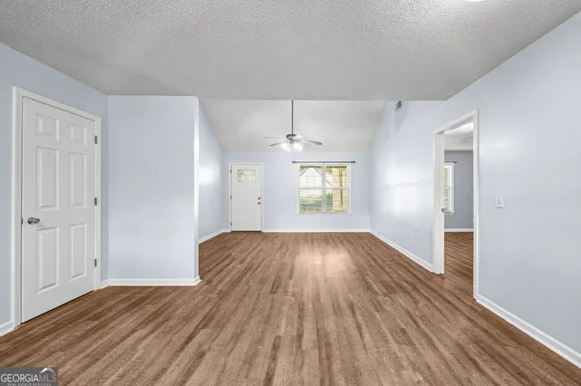 wooden floor in an empty room with a window