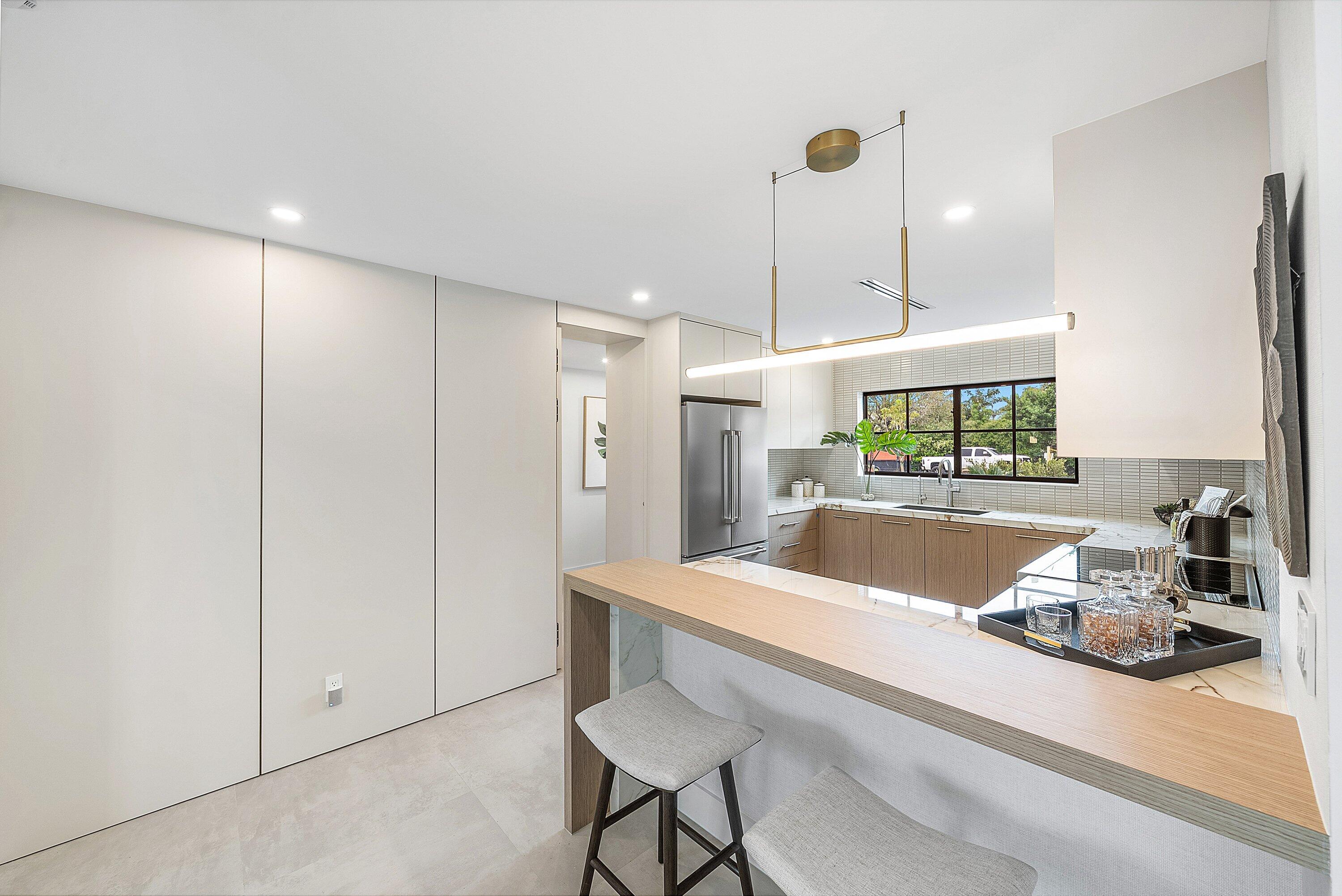 478 Northwest 13th Street Boca Raton, FL 33432 - Photo 12 of 38 a large kitchen with a table and chairs