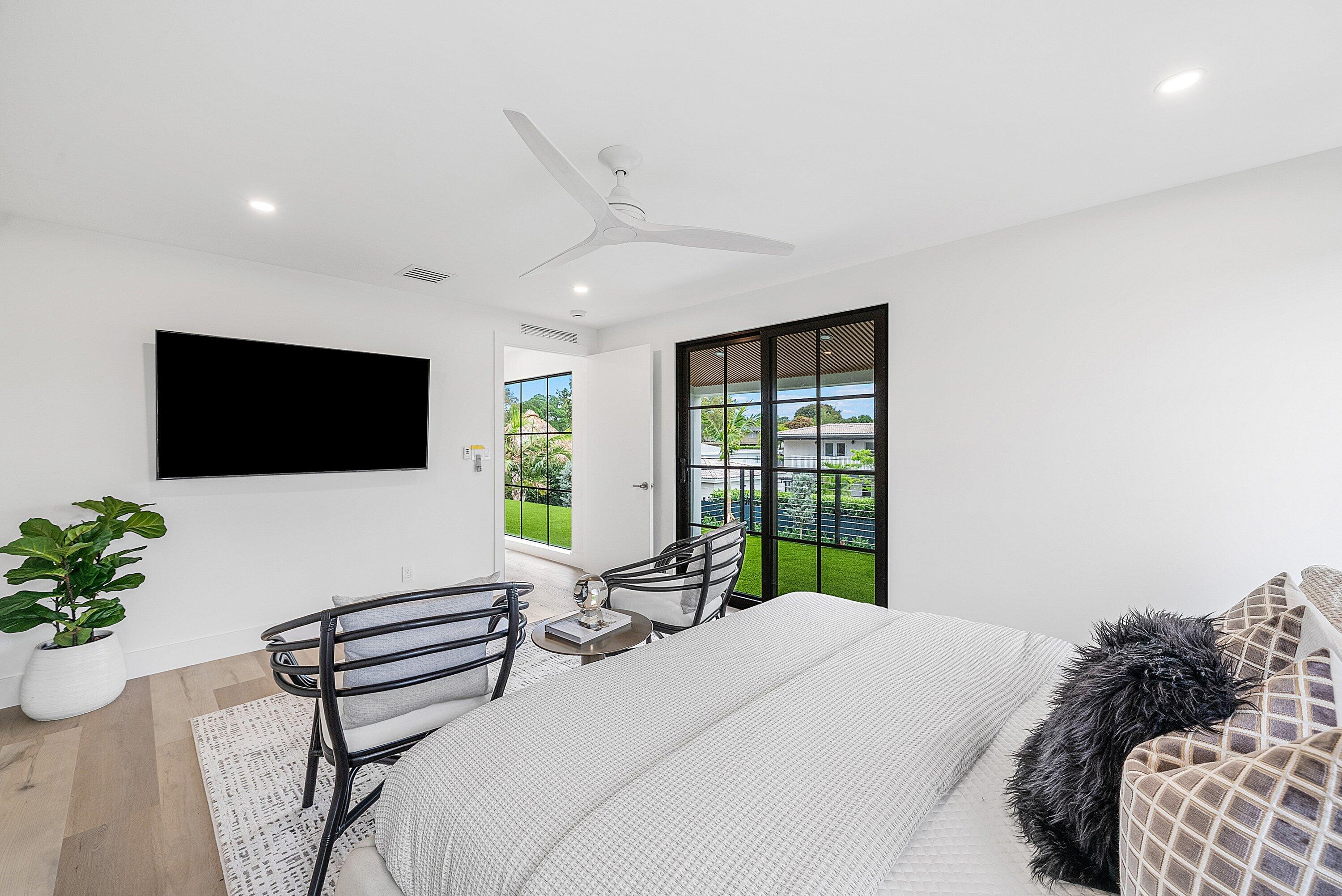 478 Northwest 13th Street Boca Raton, FL 33432 - Photo 20 of 38 a bedroom with a bed window and a flat screen tv