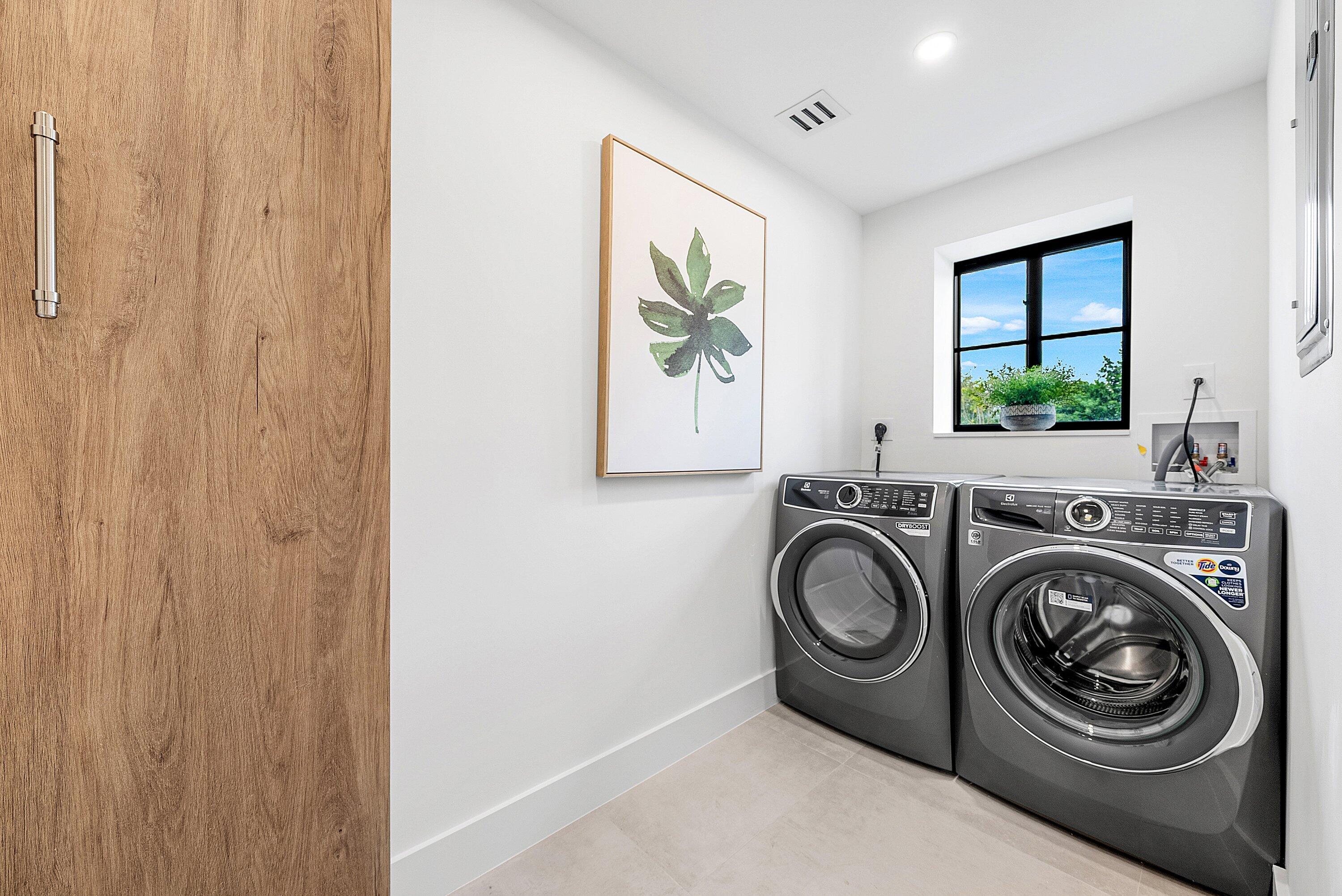 478 Northwest 13th Street Boca Raton, FL 33432 - Photo 33 of 38 a view of a hallway with washer and dryer