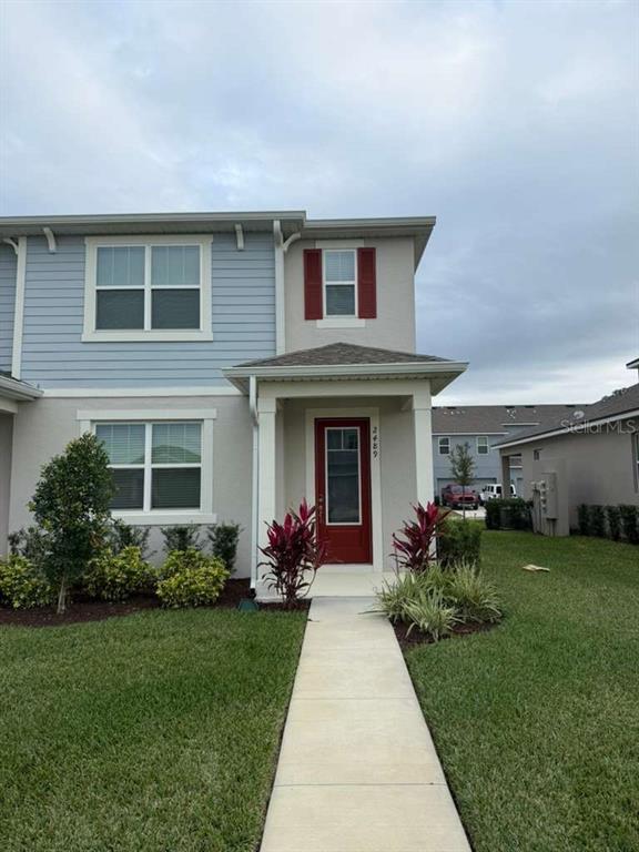 2489 Chickasaw Plum Loop Clermont, FL 34711 - Photo 1 of 5 a front view of house with yard