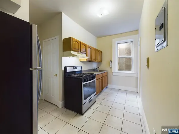 a kitchen with stainless steel appliances granite countertop a refrigerator and a stove
