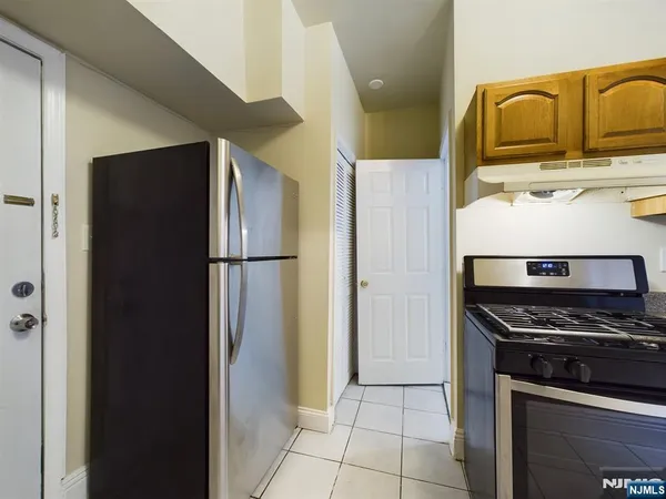 a kitchen with a refrigerator and a sink