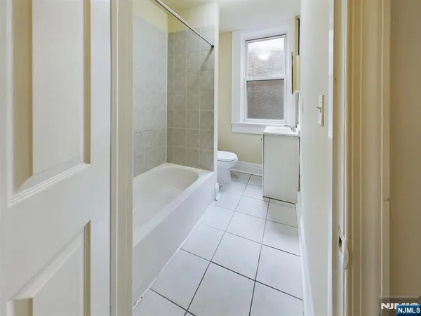 a bathroom with a bathtub and toilet