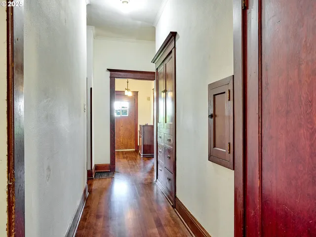 a view of a hallway with wooden floor