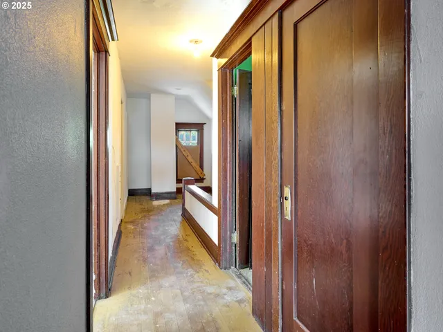 a view of a hallway with a wooden door