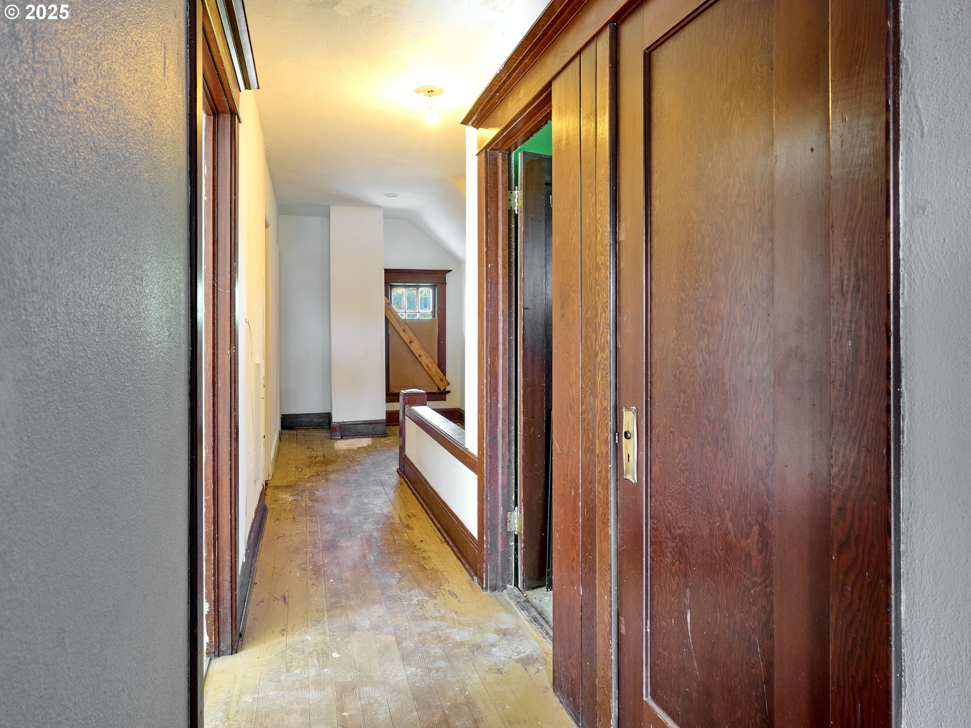 955 Bryan Street Woodburn, OR 97071 - Photo 28 of 28 a view of a hallway with a wooden door