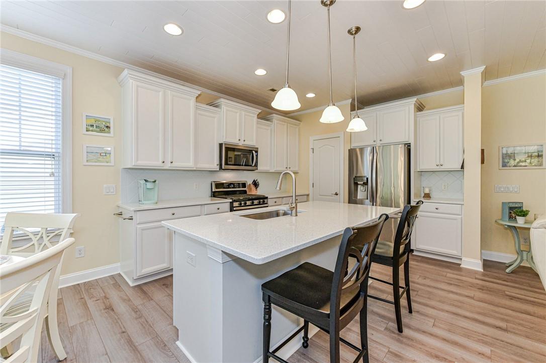 1223 Gold Rush Court Fort Mill, SC 29708 - Photo 12 of 39 a kitchen with a dining table chairs refrigerator and microwave