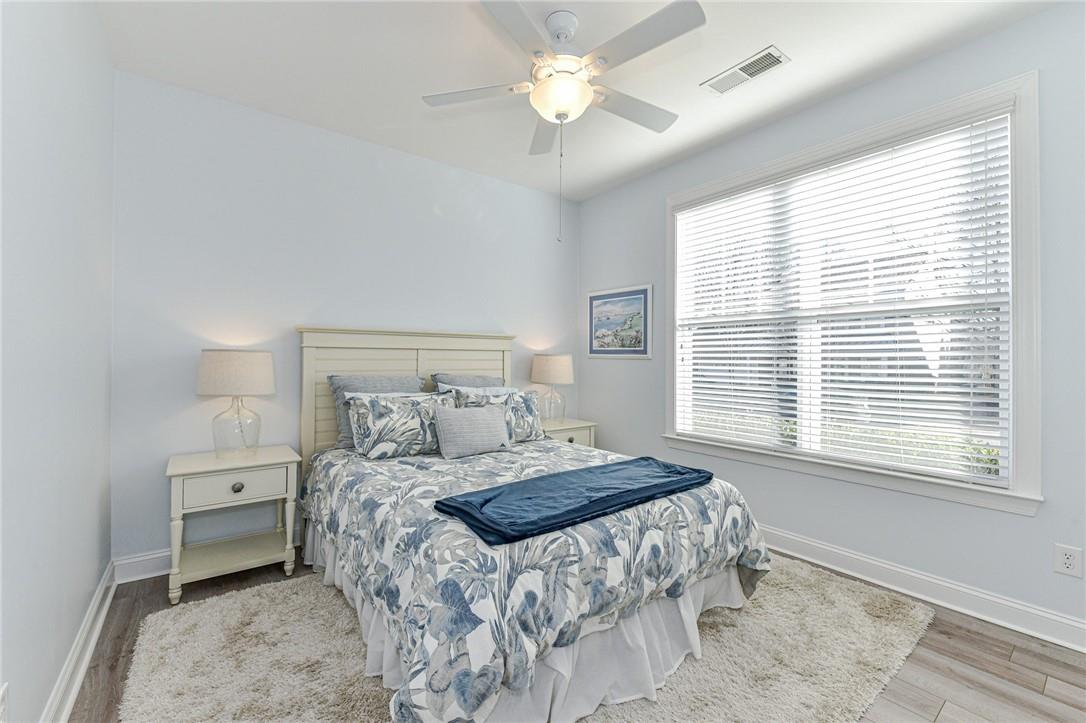 1223 Gold Rush Court Fort Mill, SC 29708 - Photo 23 of 39 a bedroom with a bed and a chandelier