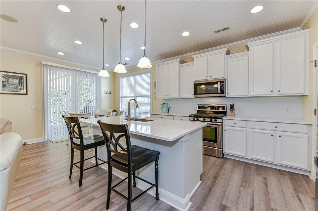 1223 Gold Rush Court Fort Mill, SC 29708 - Photo 3 of 39 a kitchen with stainless steel appliances a stove a sink a microwave a center island and cabinets