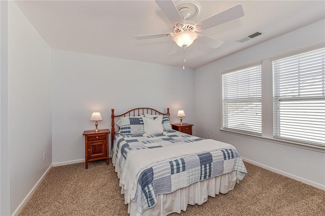 1223 Gold Rush Court Fort Mill, SC 29708 - Photo 31 of 39 a bedroom with a bed a chandelier and a window