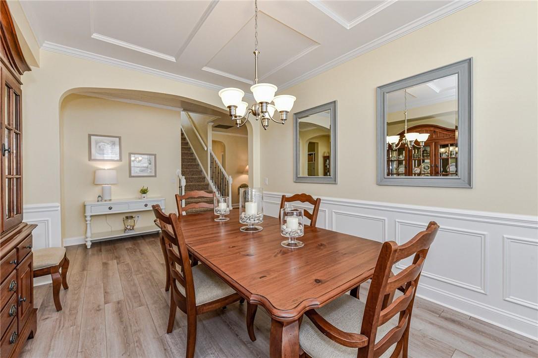 1223 Gold Rush Court Fort Mill, SC 29708 - Photo 7 of 39 a dining room with wooden floor a chandelier a wooden table and chairs
