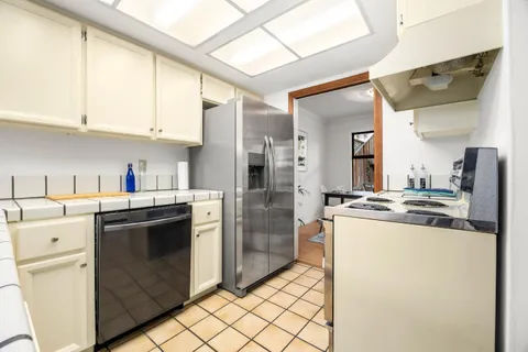 a kitchen with a sink cabinets and stainless steel appliances