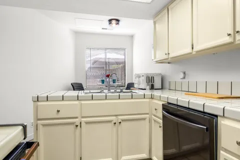 a kitchen with a sink cabinets and appliances