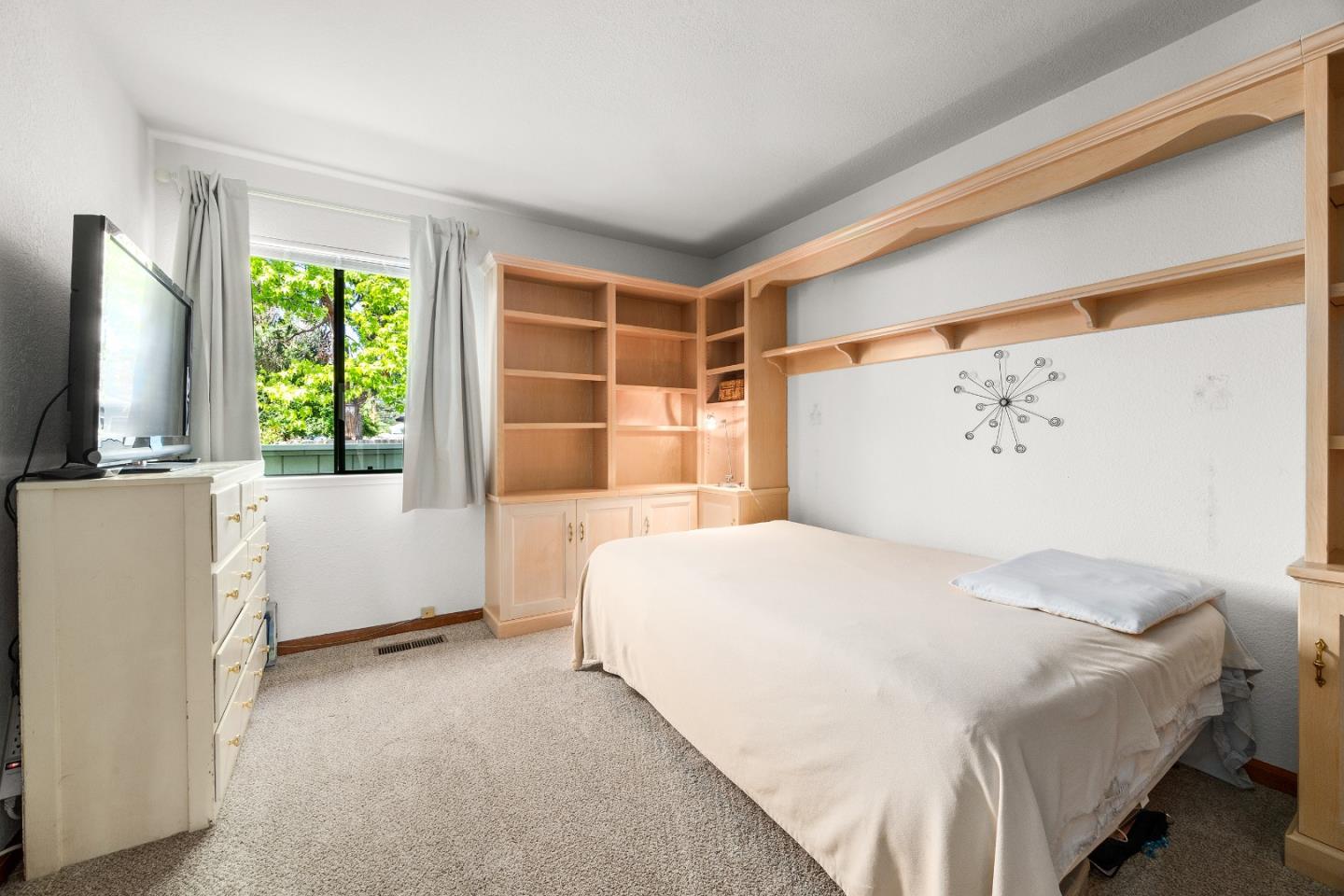 3205 Stockbridge Lane Santa Cruz, CA 95065 - Photo 18 of 30 a bedroom with a large bed and a flat tv screen