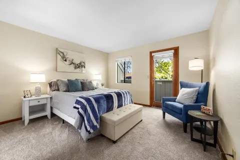 a spacious bedroom with a bed and a couch