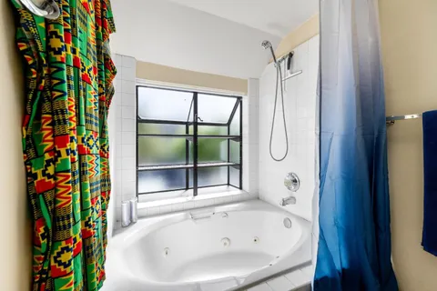 a bathroom with a bathtub and a shower curtain