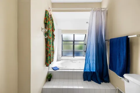 a bathroom with a bathtub and a shower
