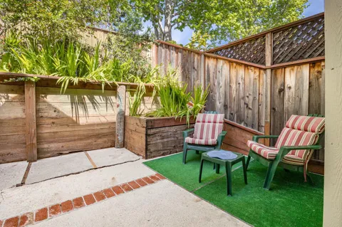 a backyard of a house with table and chairs