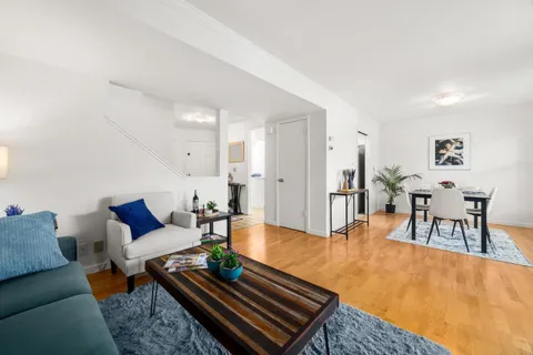 a living room with furniture and a table