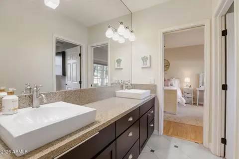 a spacious bedroom with a bed and a large window
