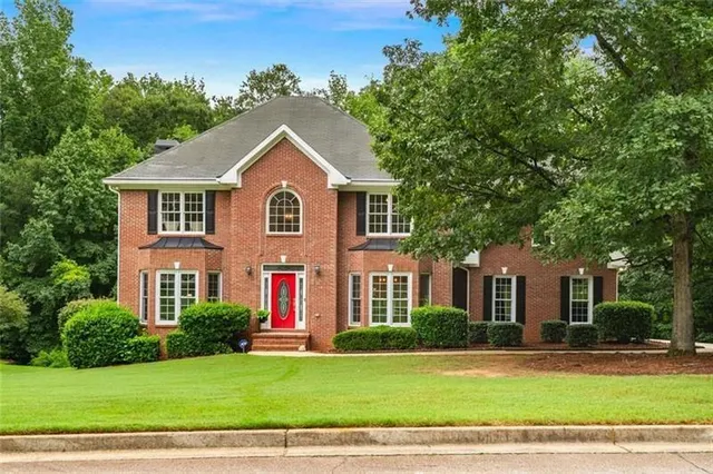 a front view of a house with a yard