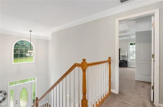 a view of a hallway with windows and entryway
