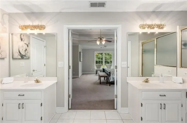 a bathroom with a sink double vanity and a mirror