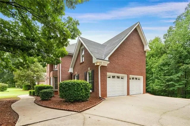 a view of a grey house with a yard