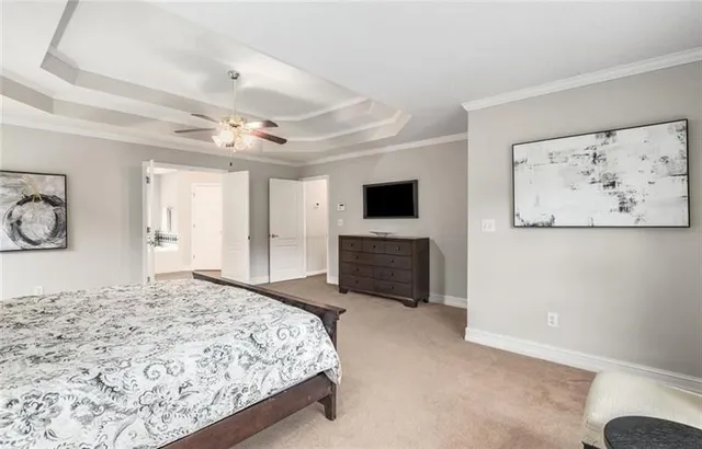 a spacious bedroom with a bed and a television