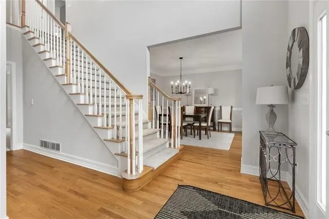 a view of entryway and hall with wooden floor