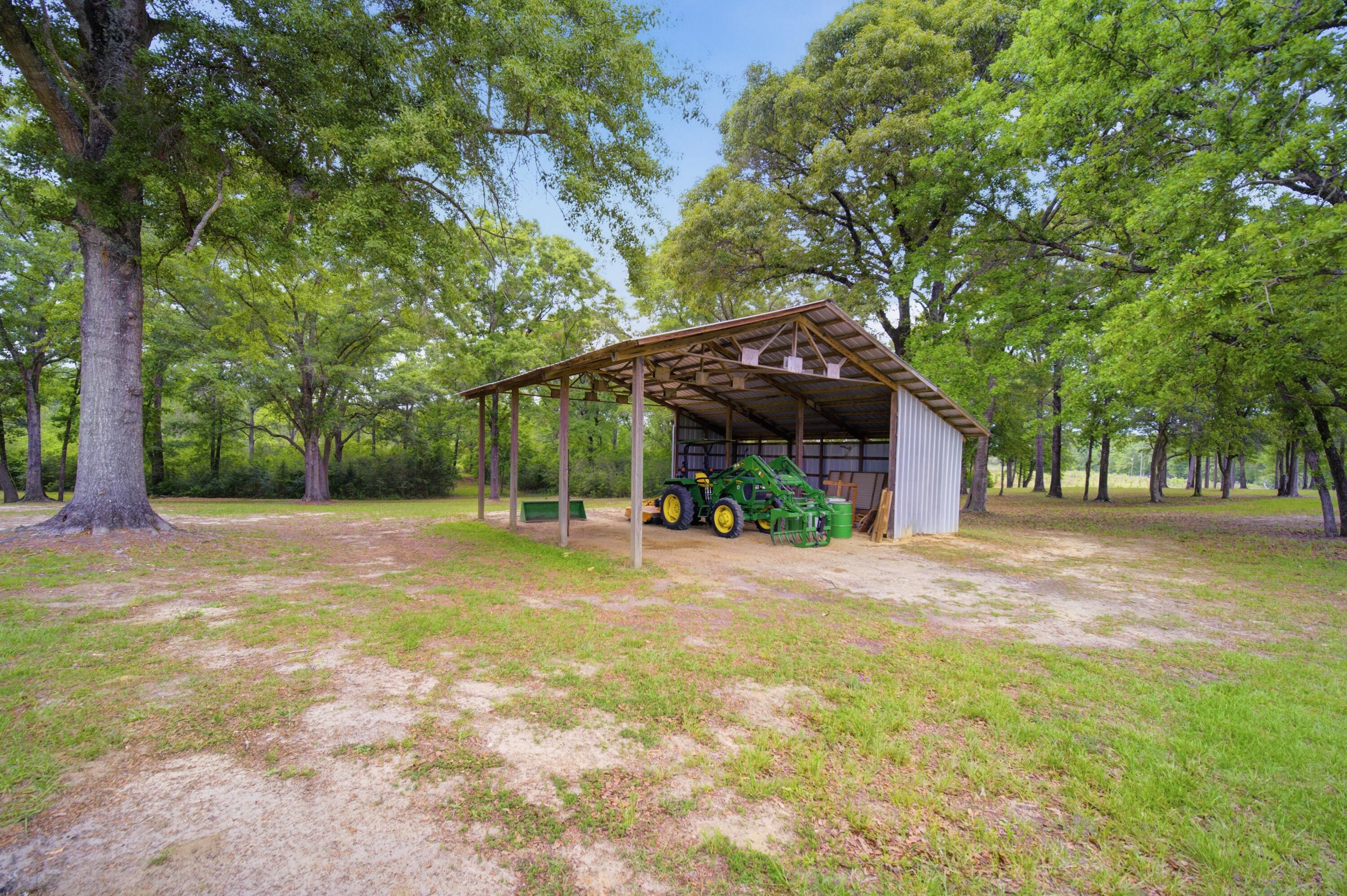 261 Wilkerson Road DeFuniak Springs, FL 32433 - Photo 70 of 76 a view of a house with a yard and tree s