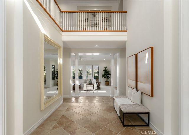 a living room with fireplace furniture and a large window
