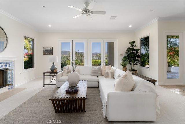 a dining room with furniture a large window and kitchen view
