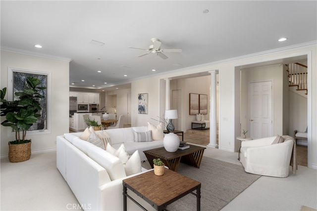 a living room with furniture and chairs