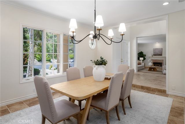 a living room with furniture a large window and a flat screen tv