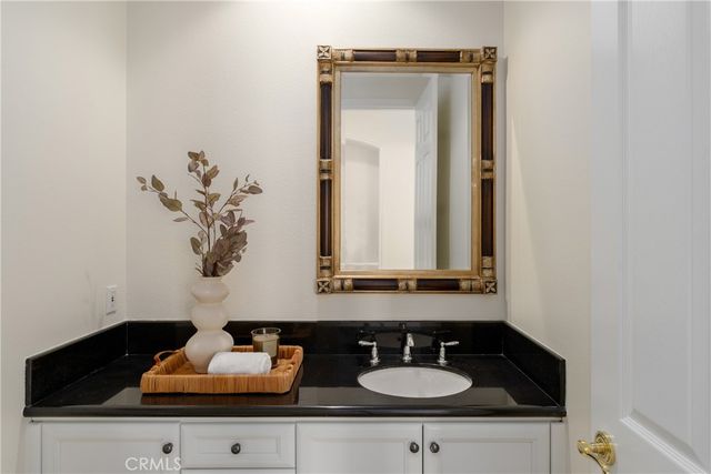 a bedroom with a bed chandelier and a window