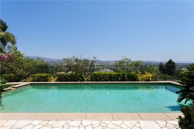 a view of a swimming pool with a yard