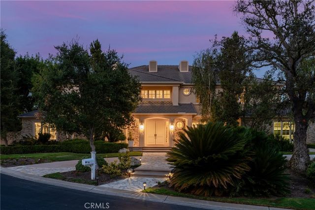 a view of a hallway with dining room and furniture