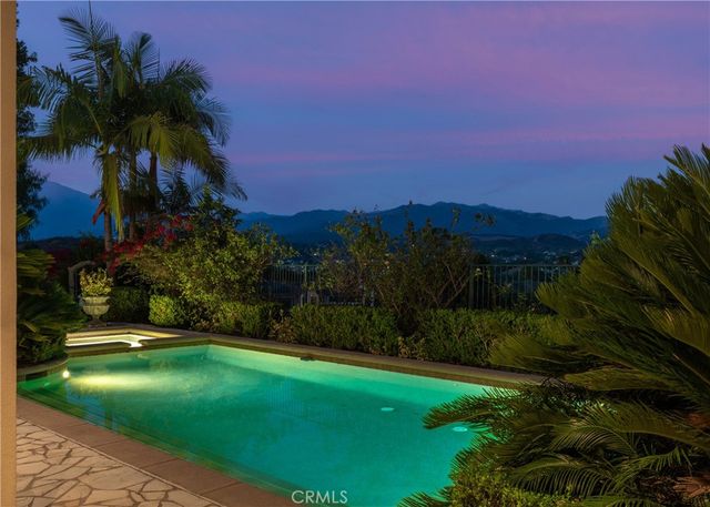a living room with furniture a fireplace and a large window