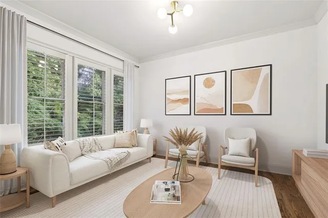 a bedroom with a large bed a chandelier and dresser