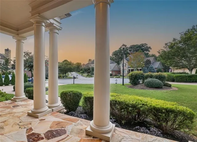 a view of a hallway with wooden floor and windows