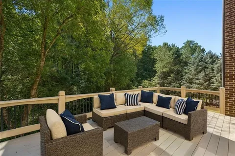 a view of a chairs and table in patio with a grill