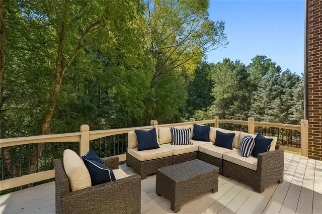 a view of a chairs and table in patio with a grill