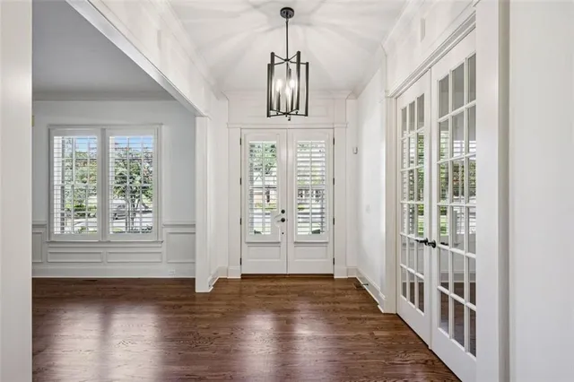 a view of a dining room with furniture wooden floor and chandelier